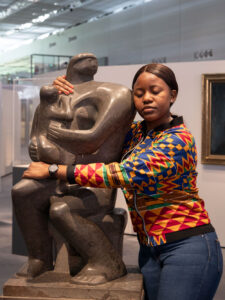 A person hugging a Henry Moore sculpture at the Sainsbury Centre Art Museum Norwich
