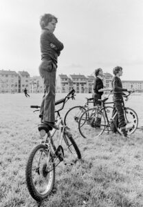 Teen boy balancing on his bike.